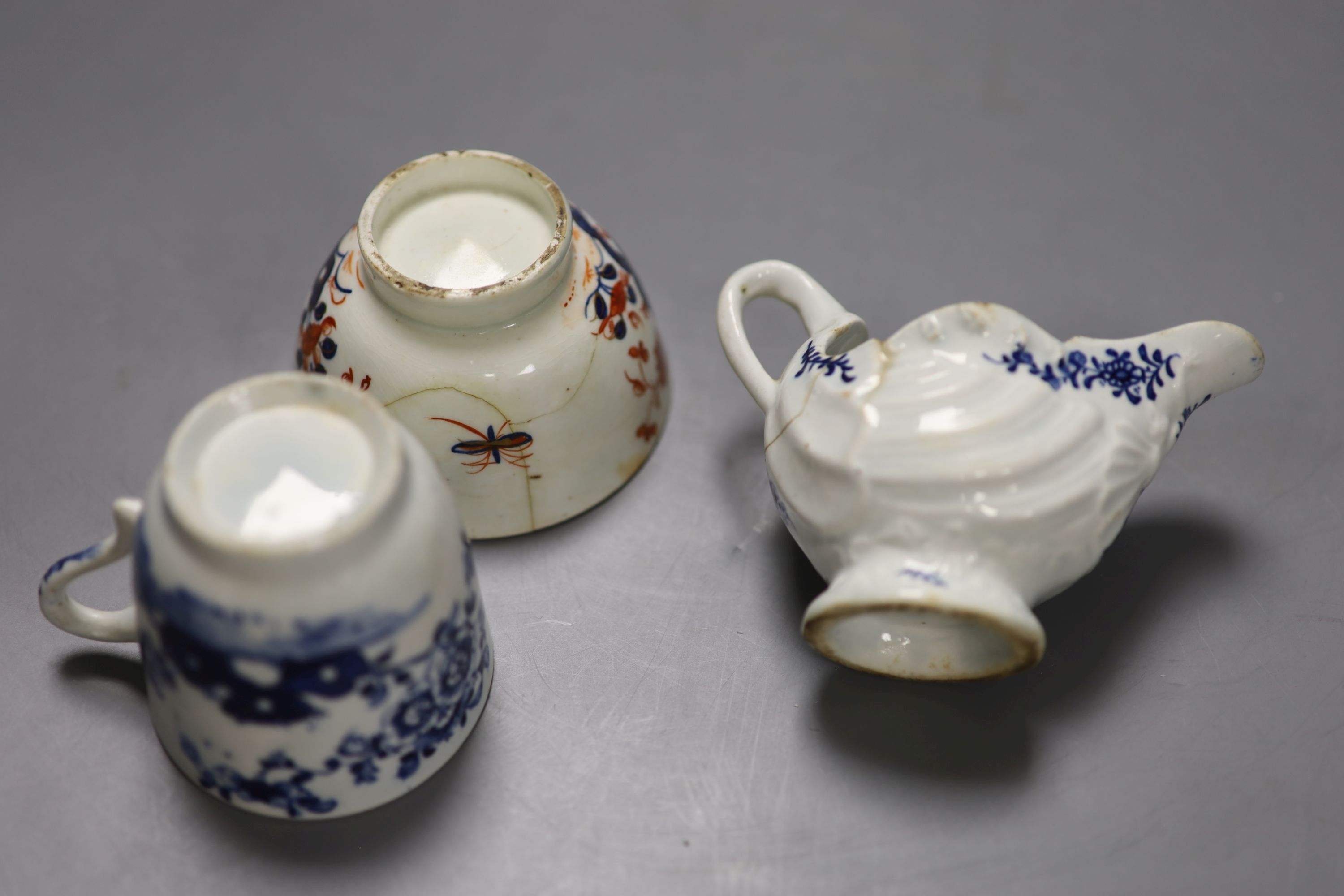 A Lowestoft shell moulded ewer painted with floral sprigs, a Lowestoft coffee cup,